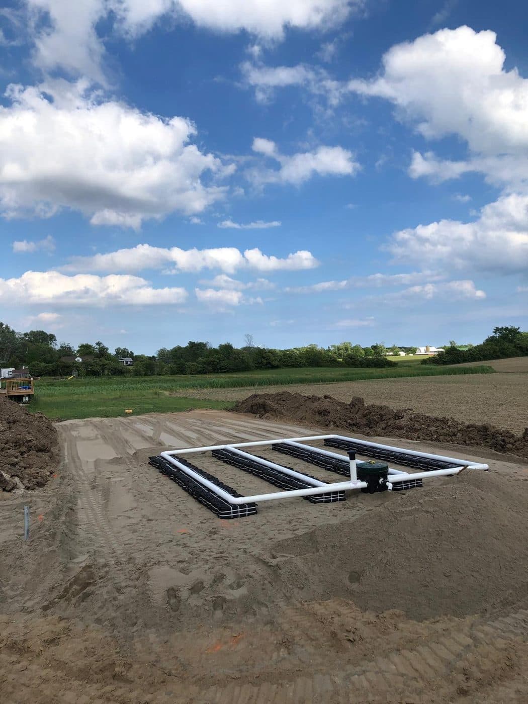 Eljen advanced leaching system with geotextile modules and distribution piping under a blue sky